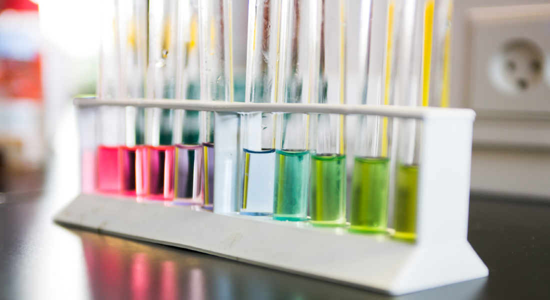 six testing tubes containing colourfull liquid